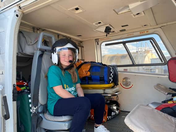 Hannah testing out the best seat in the house, inside the helicopter.