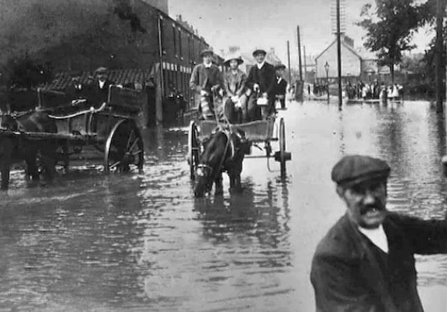 Stanground again, this time looking at the Lode in flood from the bridge on what is today South Street looking back into Stanground and the junction with Church Street (Peterborough Images Archive)