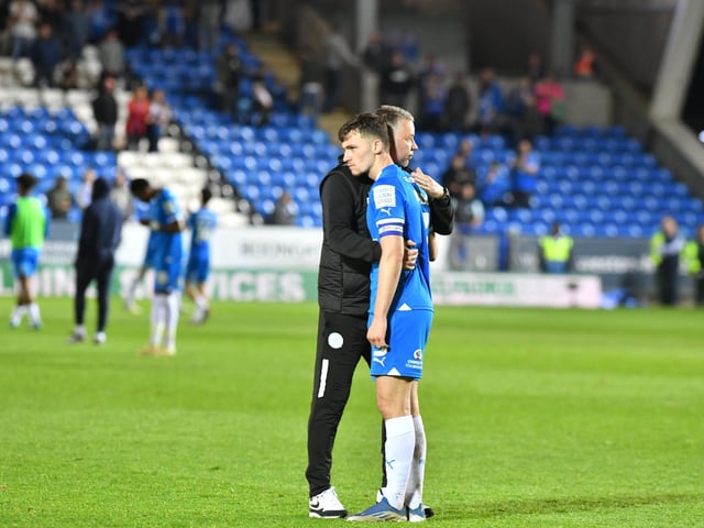 Harrison Burrows is consoled by Posh boss Darren Ferguson after last season's League One play-off semi-final defeat at the hands of Oxford United.