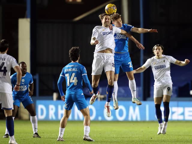 Archie Collins of Peterborough United challenges for the ball against AFC Wimbledon. Photo: Joe Dent.