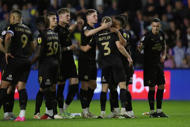 Dan Butler of Peterborough United is consoled by team-mates after missing his penalty at Hillsborough. Photo: Joe Dent.