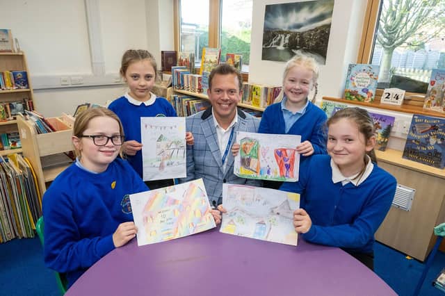 Thomas Eaton Primary Academy Executive Deputy Headteacher James Harfield and pupils with their designs which were chosen as welcome cards for new residents at Bellway’s Primrose Grove development in Wimblington: (left to right) Eve, Roxana, Freya and Esme