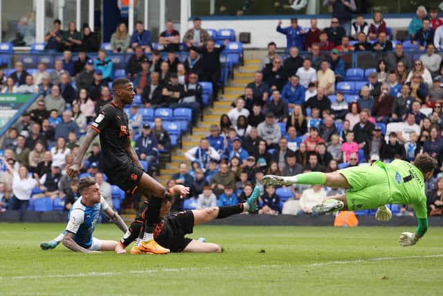 Sammie Szmodics of Peterborough United (left) scores the second goal of the game against Blackpool. Photo: Joe Dent/theposh.com