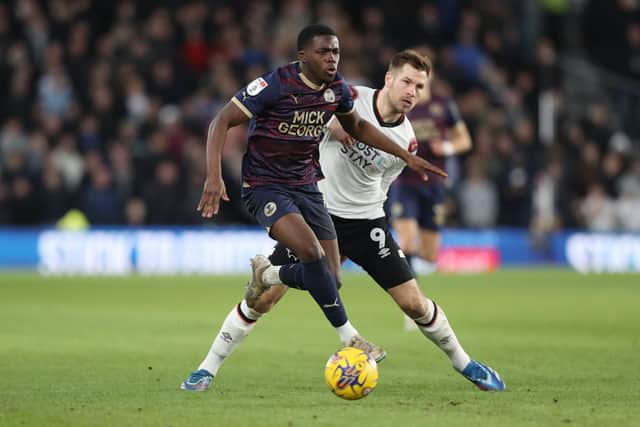 Kwame Poku of Peterborough United in action with James Collins of Derby County. Photo: Joe Dent/theposh.com