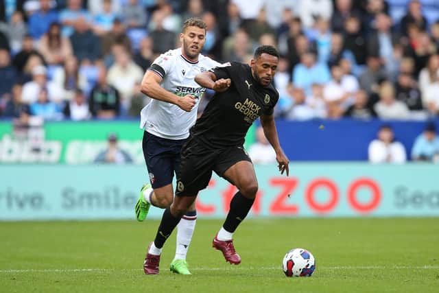 Nathan Thompson of Peterborough United in action with Dion Charles of Bolton Wanderers. Photo: Joe Dent/theposh.com.