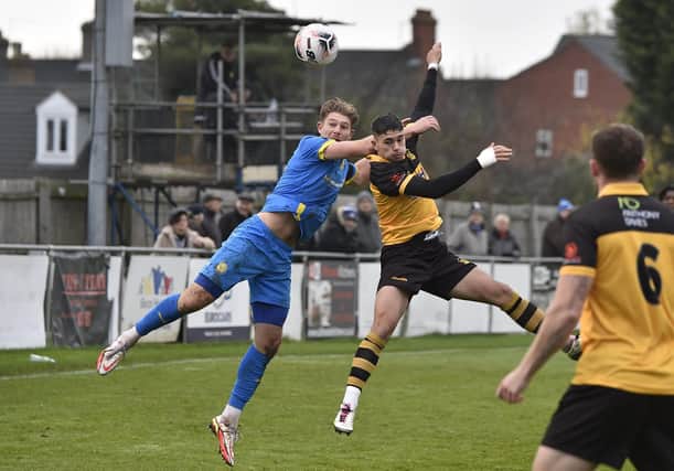 Mark Jones (blue) in action for Peterborough Sports against Cheshunt in the FA Trophy. Photo: David Lowndes.