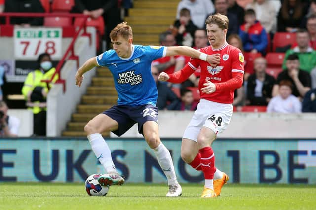 Hector Kyprianou of Peterborough United in action with Luca Connell of Barnsley. Photo: Joe Dent/theposh.com.