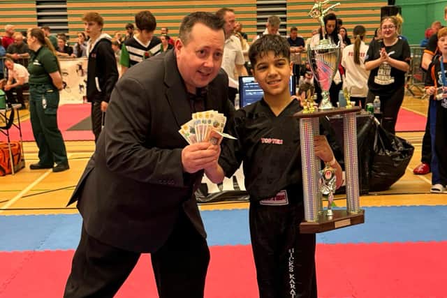 Sensei Hicks presents Ravi Panchal with his prizes at the Peterborough Series Martial Arts event.