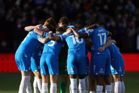 Peterborough United players huddle together before the match. Photo: Joe Dent.