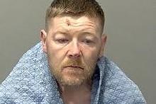 Dramatic CCTV shows moment “dangerous” robber points imitation gun in shop during crime spree