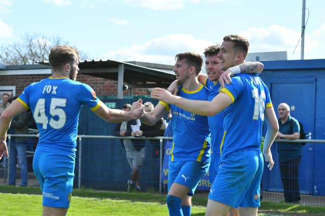Peterborough Sports players celebrate Jordan Crawford's goal against Alfreton. Crawford is in the middle of the group on the right. Photo: David Lowndes.