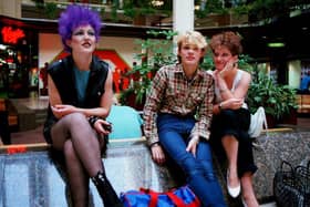 Three youngsters sitting inside Queensgate shortly after it opened