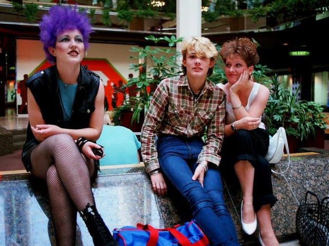 Three youngsters sitting inside Queensgate shortly after it opened