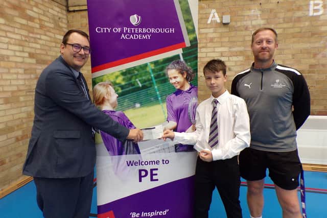 Spot the Ball competition winner Marius Lungu with Scrivens regional manager Dan Abraham (L) and City of Peterborough Academy's assistant principal, Steve Wilkinson (R).
