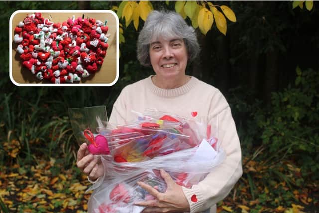 LPP Volunteer Coordinator Julie Gibson with some of the hand-crafted hearts.