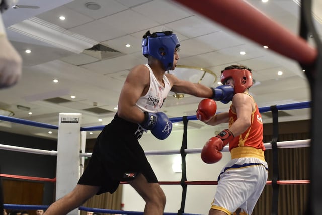 Peterborough Police boxing club boxer (blue) Subhan Raja heads to victory over Alexsandra Stepans during a Peterborough United / CAMPOL boxing show at the Holiday Inn in 2019.