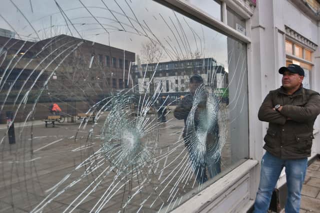 Regismar Dos Reis at his furniture store at Rivergate, where the windows have been smashed.