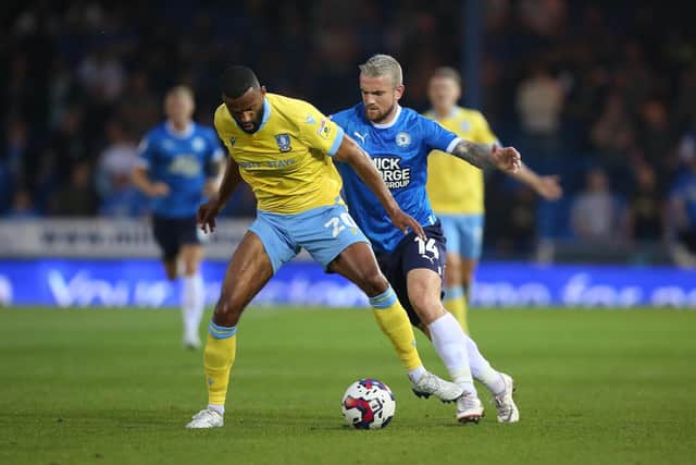 Jack Marriott of Peterborough United puts Michael Ihiekwe of Sheffield Wednesday under pressure. Photo: Joe Dent.