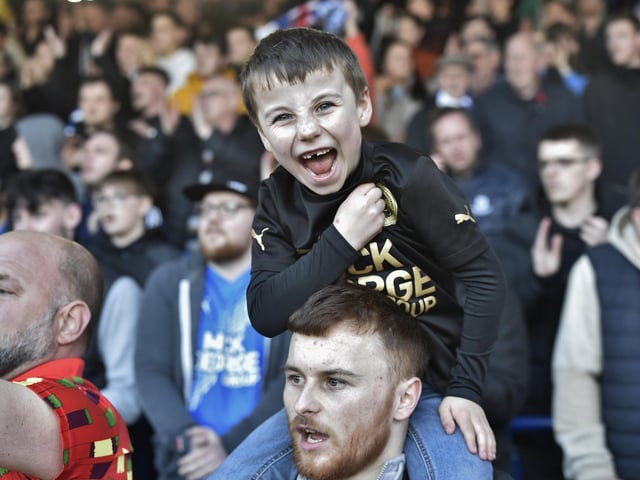 Peterborough United fans are pictured watching the crucial win over Derby County.