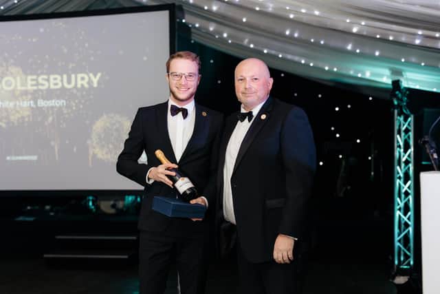 Dominic Solesbury receives his Support Person of the Year Award from Mark Chapman,  the Group Regional Operations Manager of the Coaching Inn Group.