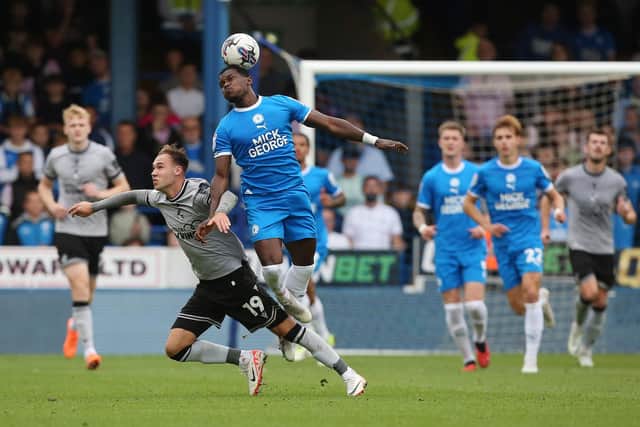 Ephron Mason-Clark of Peterborough United challenges for the ball with Harvey Vale of Bristol Rovers. Photo: Joe Dent.