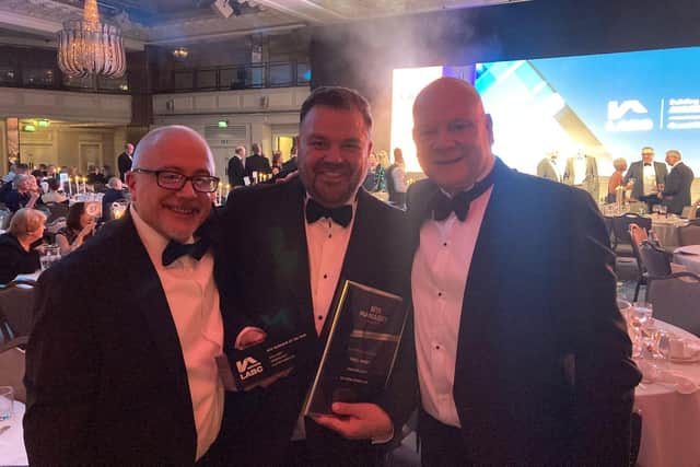 Paul Vasey, former site manager and now construction manager at Allison Homes East, centre, with his National Site Manager of The Year Award from LABC Warranty.
