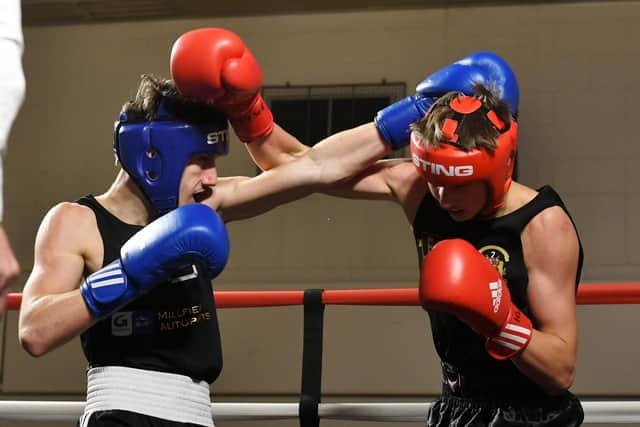 Aron Migra (blue) of Top Yard in action at Gladstone Community Centre. Photo: David Lowndes