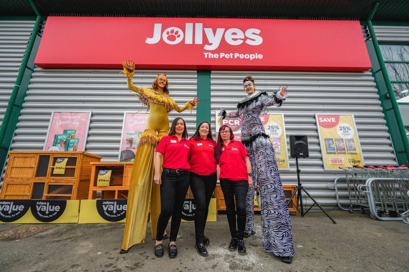 Mandy Adams, Lyndsey Fearnns and Tracy Shippam with the stilt walkers at the official opening of Jollyes pet store in Peterborough.