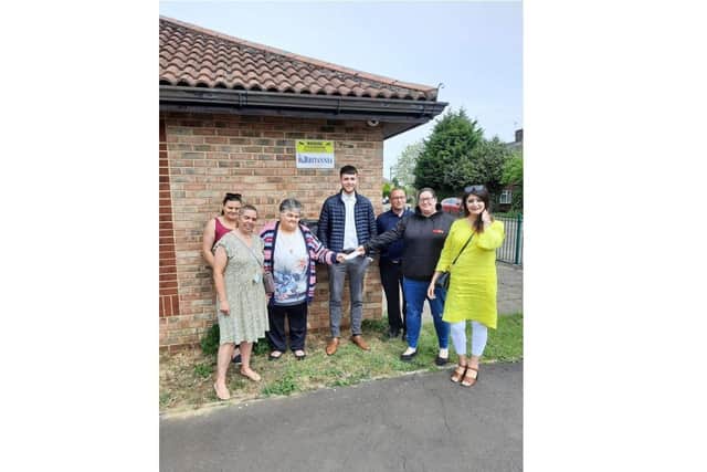 Community Centre leader Evelyn Speechley hands over the cheque to Gemma Wells from Gemma's Hearts, also in attendance, Cllr Sam Hemraj (left), Shabina Qayyum (right) and representatives from Britannia Fire and Security Ltd.