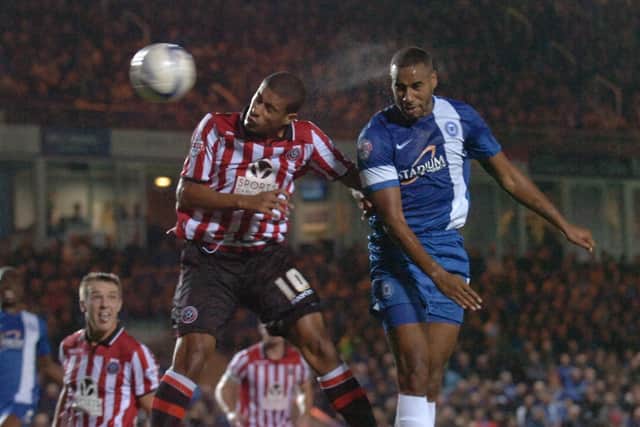 Tyrone Barnett (right) in action for Posh. Photo: David Lowndes.