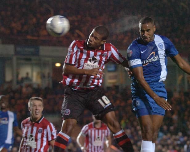 Tyrone Barnett (right) in action for Posh. Photo: David Lowndes.