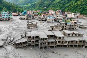 An aerial view shows houses lying deluged in sludge after flash floods at Devighat, Bidur Municipality in Nepal's Nuwakot district on August 27, 2026. (Photo by Prabin RANABHAT / AFP via Getty Images).