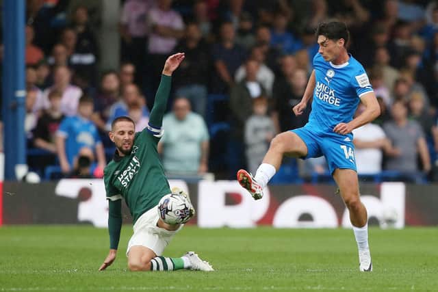 Joel Randall of Peterborough United in action with Conor Hourihane of Derby County. Photo: Joe Dent/theposh.com