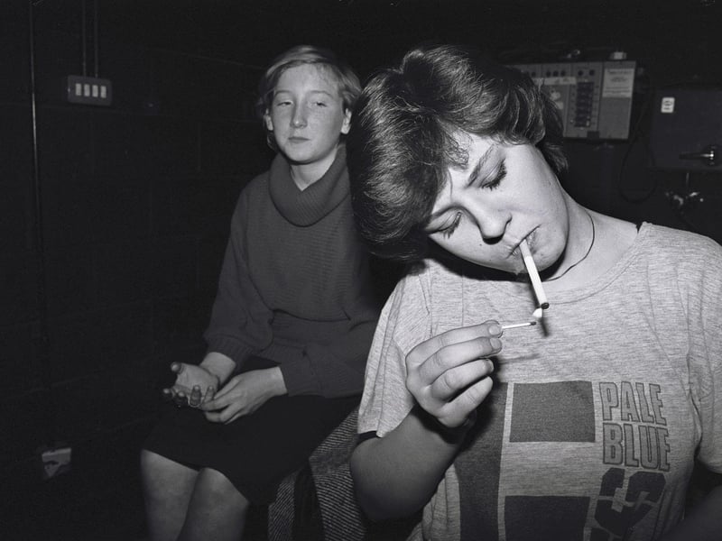 A girl lights a cigarette during a break in rehearsals at the Young People's Theatre Company at Bretton-Woods school in Peterborough, 1985.