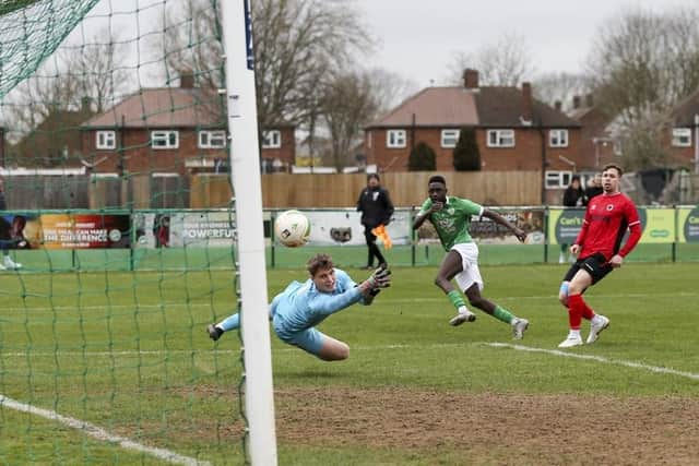 Santos Camara (green) scored for FC Peterborough v Biggleswade United.