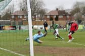 Santos Camara (green) scored for FC Peterborough v Biggleswade United.