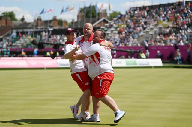 Louis Ridout (R), Jamie Chestney (C) and Nick Brett (L) of Team England celebrate winning  the Men's Triples Gold medal match. (Photo by Nathan Stirk/Getty Images).