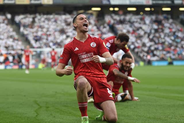 Klaidi Lolos celebrates a goal for Crawley. (Photo by Harriet Lander/Getty Images).