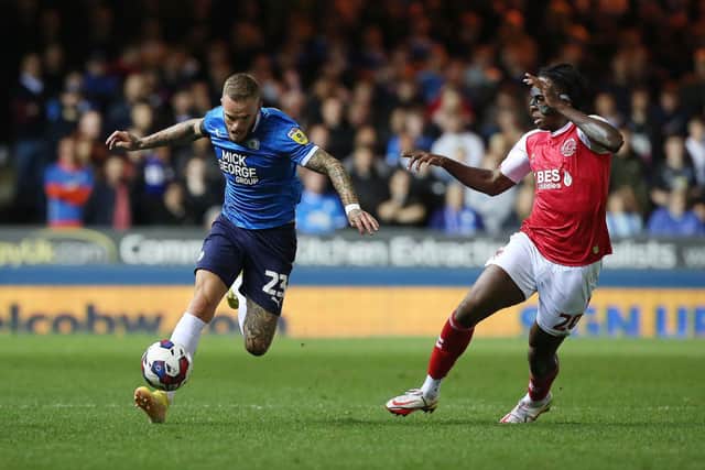 Joe Ward of Peterborough United in action with Promise Omochere of Fleetwood Town. Photo: Joe Dent/theposh.com