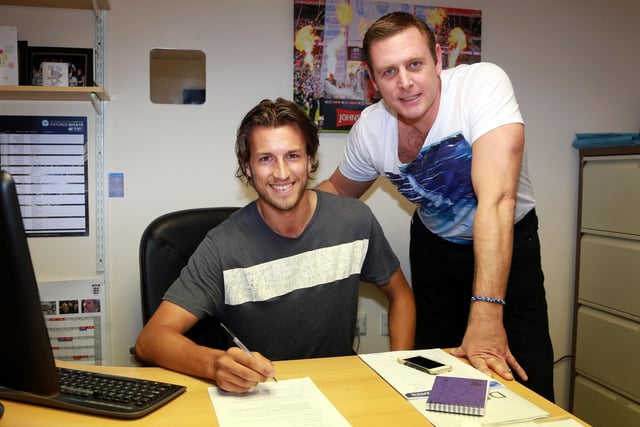 Christian Burgess signing for Peterborough United from Middlesbrough with Chairman Darragh MacAnthony. Burgess ended up playing 30 times for the club in the 2014/15 season.