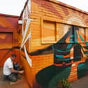 Nathan Murdoch re-painting the old toilet block on the Embankment