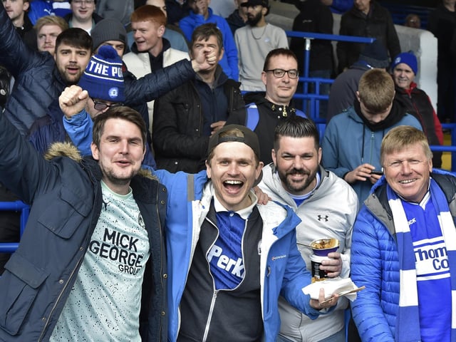Peterborough United fans are pictured watching the crucial win over Derby County.