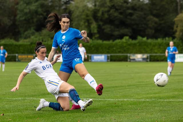 Tara Kirk (blue) in action for Posh Women against Leeds United. Photo: Ruby Red Photography