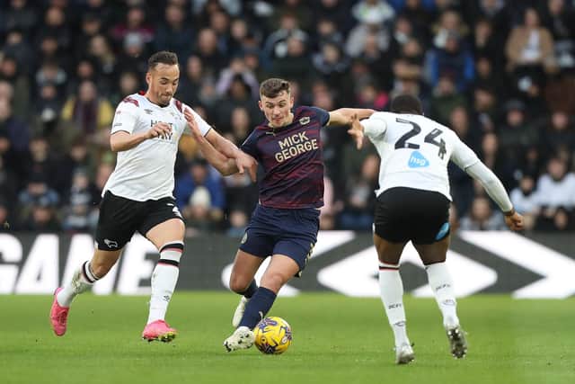Harrison Burrows in action with Kane Wilson of Derby County. Photo: Joe Dent/theposh.com/