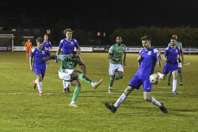 Romoe Ugbene (green) shoots at goal for FC Peterborough against Whitton United. Photo Tim Symonds.