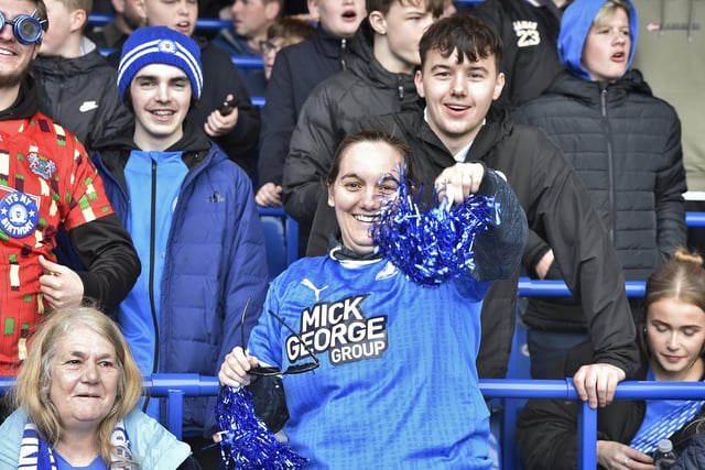 Peterborough United fans are pictured watching the crucial win over Derby County on 25th March 2023.