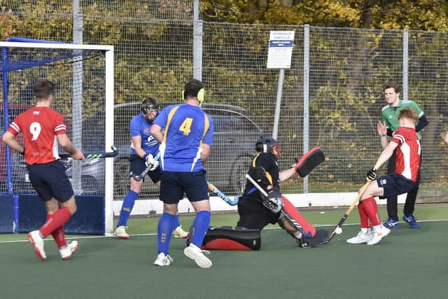 Hockey action from City of Peterborough (red) v  Stourport at Bretton Gate. Photo: David Lowndes.