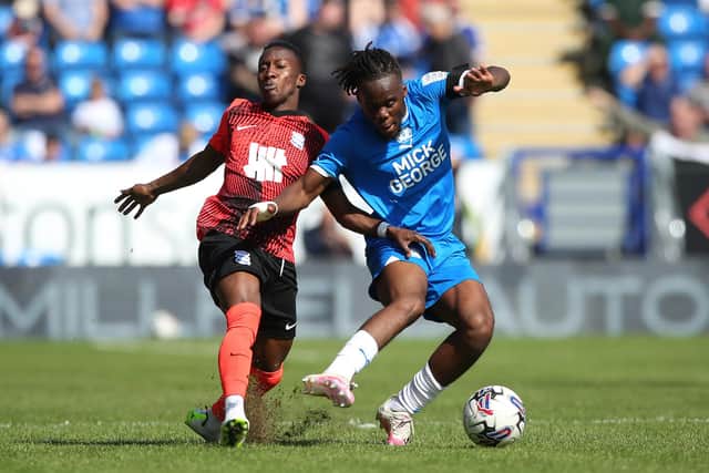 Peter Kioso of Peterborough United battles with Siriki Dembele of Birmingham City. Photo: Joe Dent/theposh.com