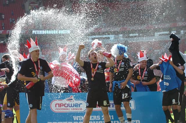 Charlie Lee leads the celebrations after a Posh win in the League One play-off final at Old Trafford in 2011. Photo: David Lowndes.