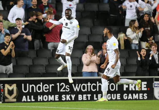 Mo Eisa celebrates a goal for MK Dons (Photo by Pete Norton/Getty Images).